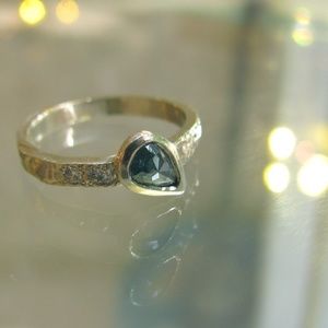 White gold ring with blue and white diamonds.